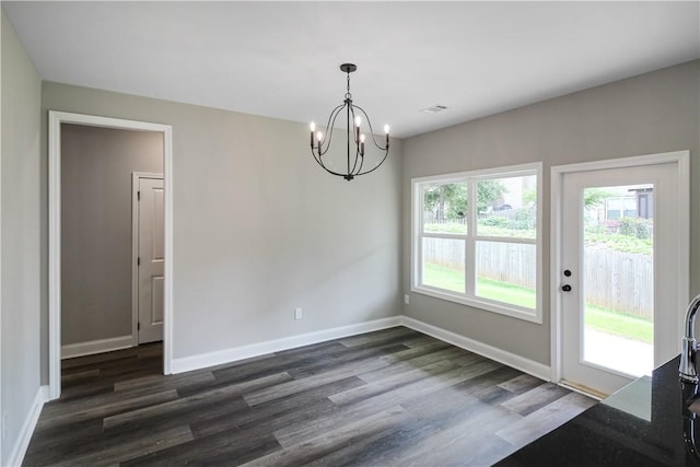 369 Lightness Dr, Auburn, AL 36832 - unfurnished dining area featuring a chandelier, dark wood-type flooring, and baseboards
