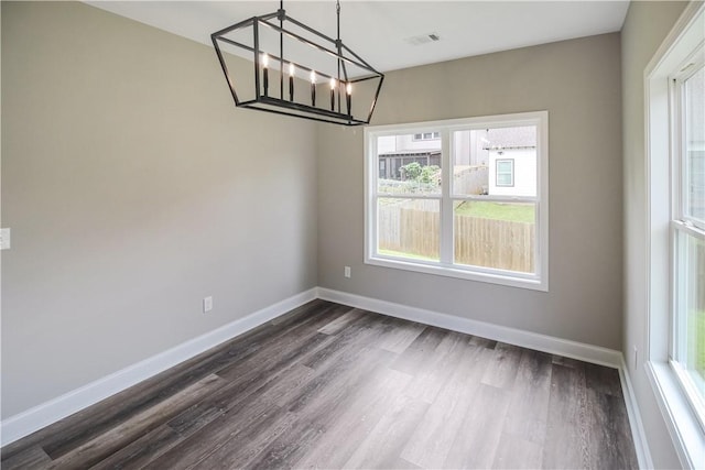 369 Lightness Dr, Auburn, AL 36832 - unfurnished dining area featuring healthy amount of natural light, dark wood-style flooring, a chandelier, and baseboards