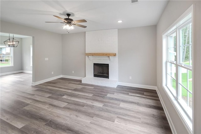 369 Lightness Dr, Auburn, AL 36832 - unfurnished living room featuring healthy amount of natural light, a brick fireplace, baseboards, and recessed lighting