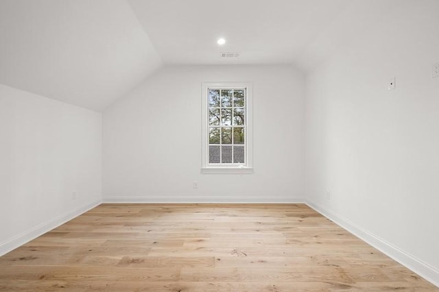 bonus room with vaulted ceiling and light hardwood / wood-style floors