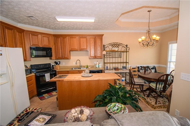 kitchen featuring sink, butcher block countertops, pendant lighting, a textured ceiling, and black appliances