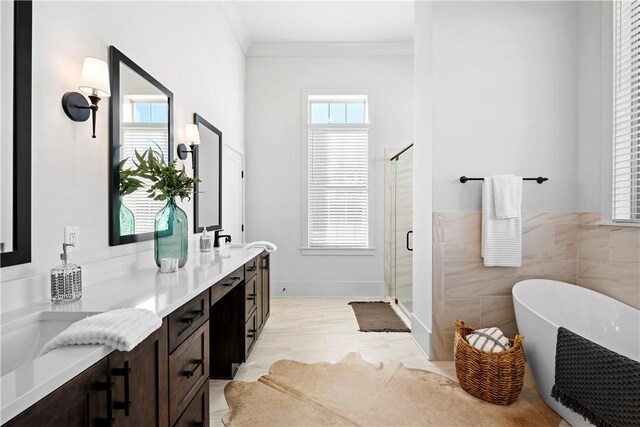 124 Merlin St, Opelika, AL 36801 - bathroom featuring ornamental molding, double vanity, a soaking tub, and a stall shower
