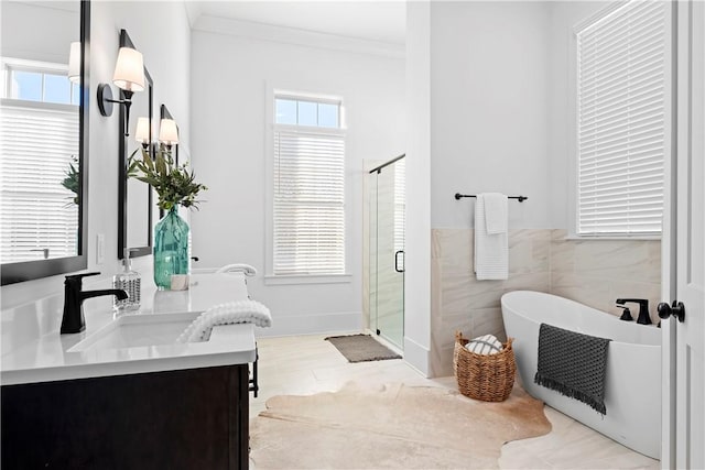 124 Merlin St, Opelika, AL 36801 - bathroom featuring a soaking tub, a stall shower, double vanity, healthy amount of natural light, and ornamental molding