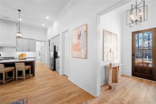 124 Merlin St, Opelika, AL 36801 - entrance foyer with a chandelier, light wood finished floors, a towering ceiling, crown molding, and recessed lighting