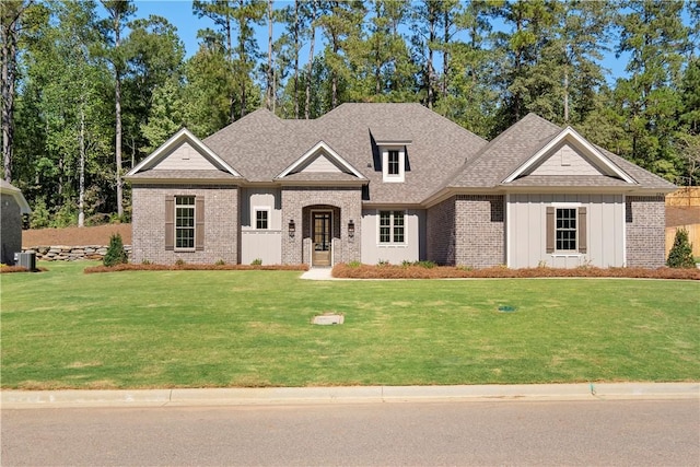 124 Merlin St, Opelika, AL 36801 - view of front of property featuring brick siding, a front yard, board and batten siding, and roof with shingles