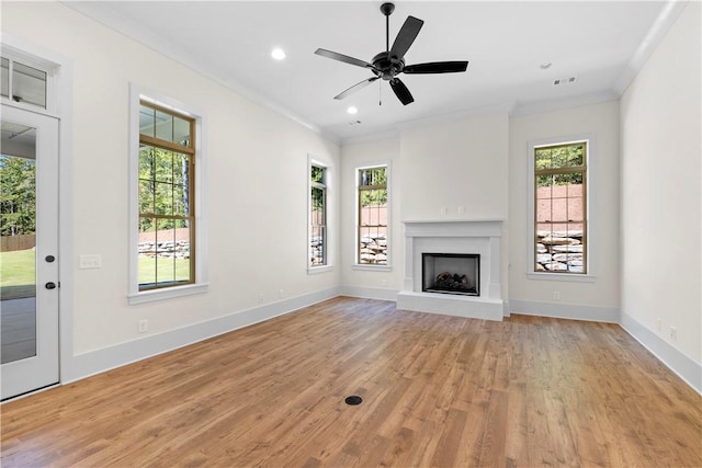 unfurnished living room featuring ceiling fan, light wood-type flooring, and crown molding