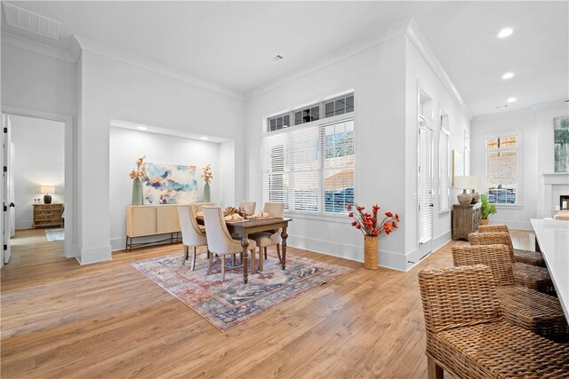 124 Merlin St, Opelika, AL 36801 - dining area with ornamental molding, light wood-style flooring, recessed lighting, and a fireplace