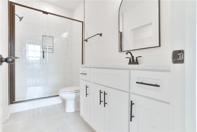 bathroom with toilet, vanity, tile patterned floors, and walk in shower