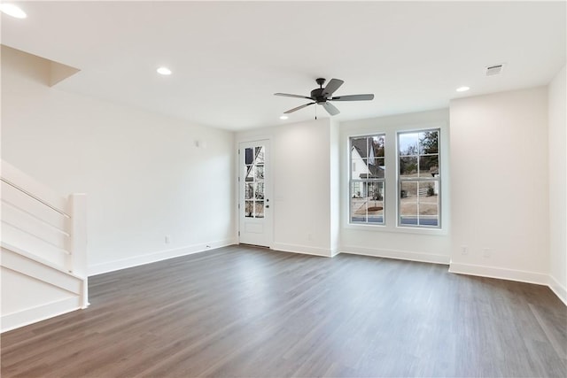 empty room with ceiling fan and dark wood-type flooring