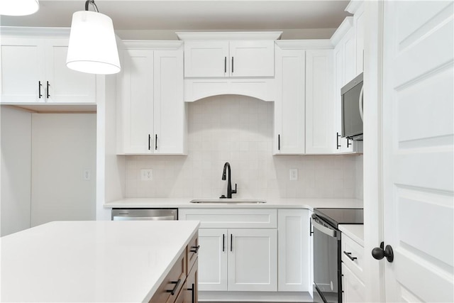 kitchen featuring white cabinets, range, and sink