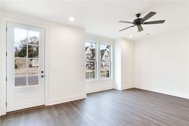 interior space with ceiling fan and dark hardwood / wood-style flooring