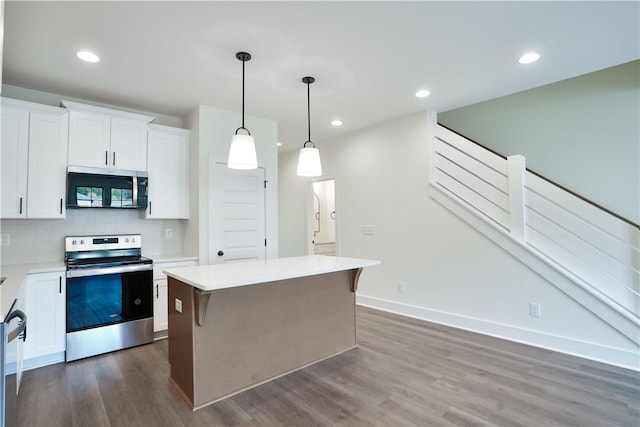 kitchen featuring dark hardwood / wood-style flooring, decorative light fixtures, white cabinets, a kitchen island, and stainless steel range with electric cooktop