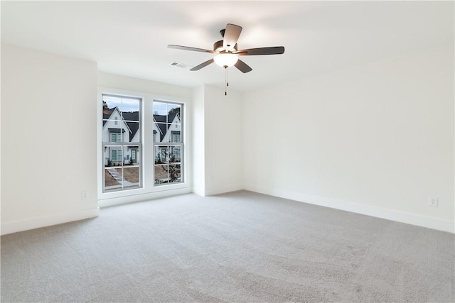 carpeted empty room featuring ceiling fan