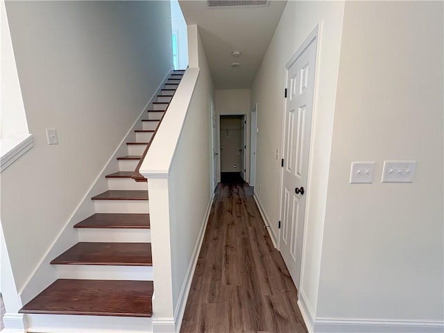 staircase with hardwood / wood-style flooring