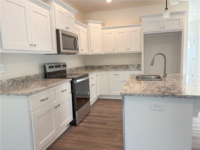 kitchen featuring sink, stainless steel appliances, light stone counters, an island with sink, and white cabinets