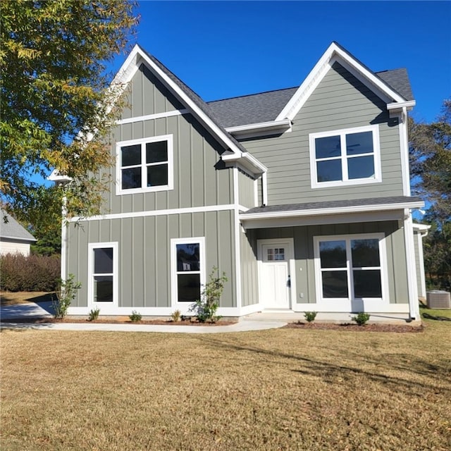 view of front facade with central AC and a front yard