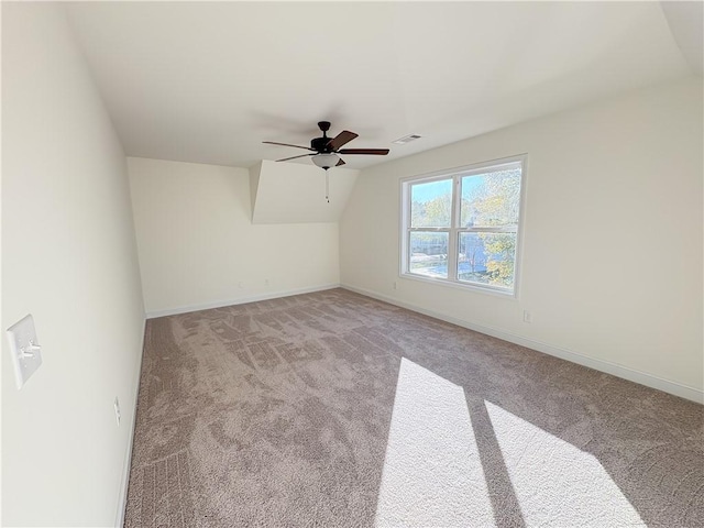 additional living space with ceiling fan, light colored carpet, and lofted ceiling