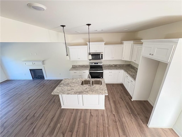 kitchen featuring white cabinets, sink, hanging light fixtures, dark hardwood / wood-style floors, and stainless steel appliances