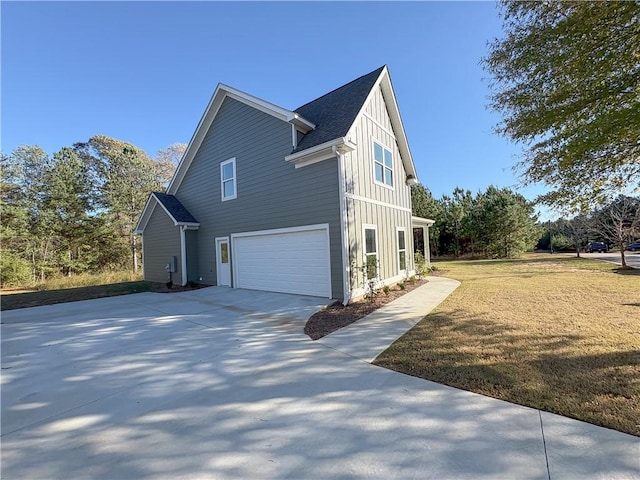 view of side of property with a garage and a lawn