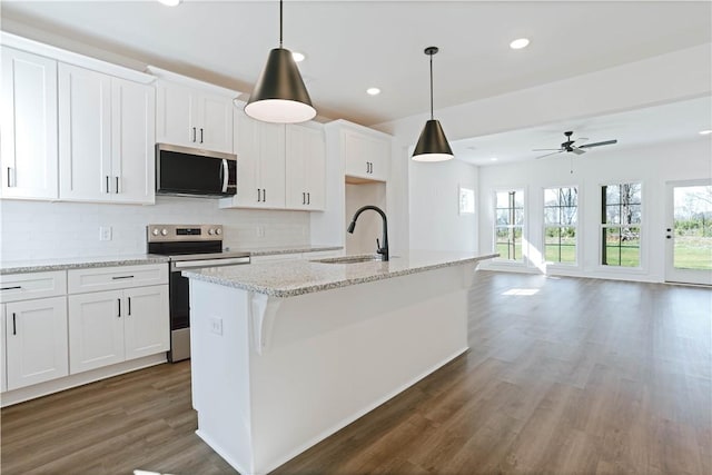 1021 Crossing Ct E, Valley, AL 36854 - kitchen featuring appliances with stainless steel finishes, dark wood-type flooring, recessed lighting, tasteful backsplash, and an island with sink
