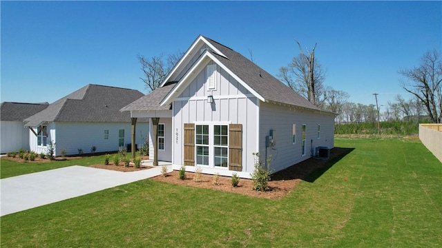1021 Crossing Ct E, Valley, AL 36854 - view of front facade featuring board and batten siding, a front lawn, and a shingled roof