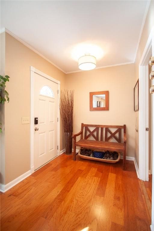 entrance foyer with hardwood / wood-style floors and crown molding