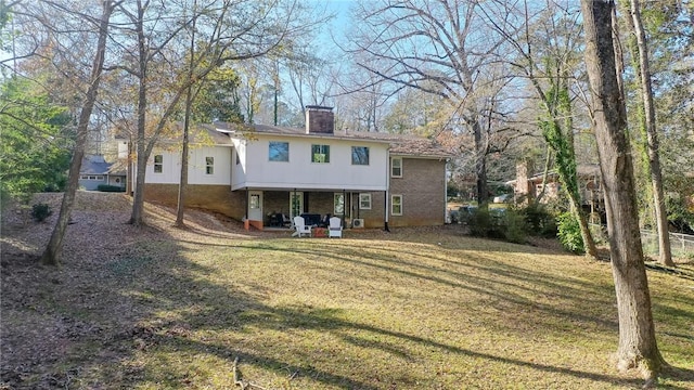 back of house featuring a lawn