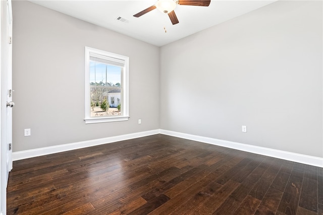 unfurnished room featuring a ceiling fan, dark wood finished floors, visible vents, and baseboards