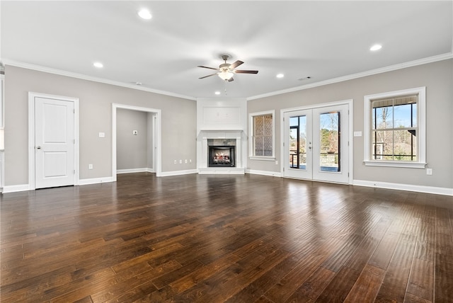 unfurnished living room with recessed lighting, a fireplace, baseboards, dark wood finished floors, and crown molding