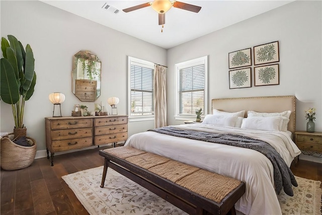 bedroom with visible vents, dark wood finished floors, and ceiling fan