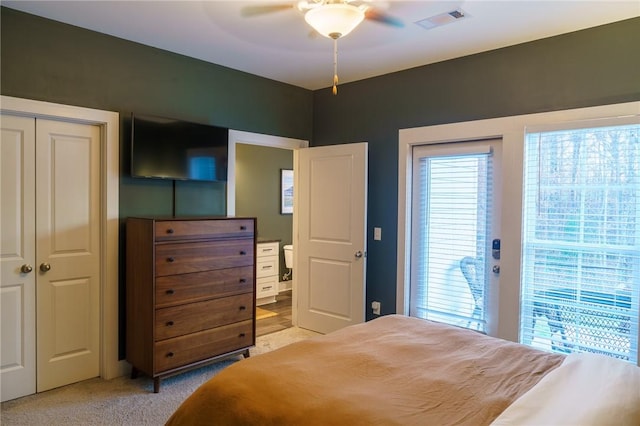 bedroom with ceiling fan, visible vents, and light carpet