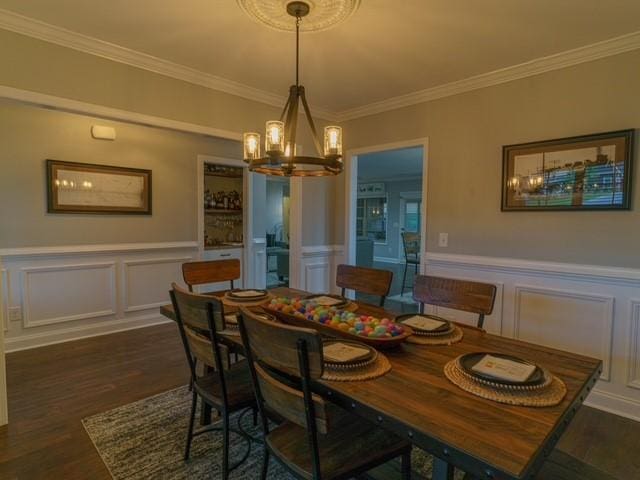 1201 Live Oak Cir, Opelika, AL 36801 - dining area featuring a chandelier, a decorative wall, dark wood finished floors, ornamental molding, and a wainscoted wall