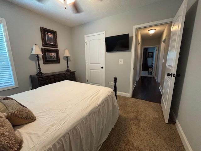 1201 Live Oak Cir, Opelika, AL 36801 - bedroom with dark carpet, ceiling fan, and multiple windows