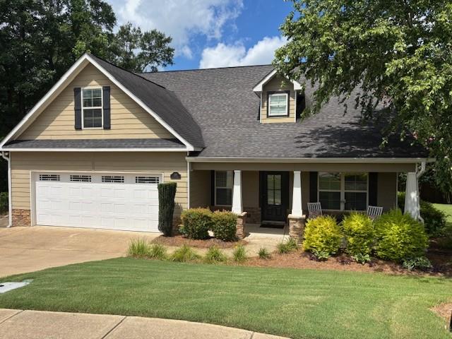 1201 Live Oak Cir, Opelika, AL 36801 - view of front of property featuring a porch, a front lawn, concrete driveway, and a shingled roof