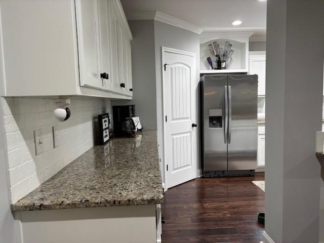 1201 Live Oak Cir, Opelika, AL 36801 - kitchen with stainless steel fridge, crown molding, white cabinets, tasteful backsplash, and dark wood-style floors