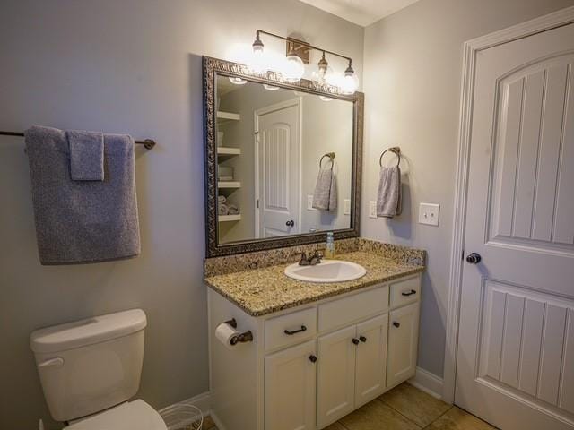 1201 Live Oak Cir, Opelika, AL 36801 - bathroom with vanity, toilet, tile patterned floors, and baseboards