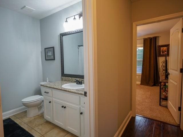 1201 Live Oak Cir, Opelika, AL 36801 - bathroom featuring vanity, toilet, and baseboards
