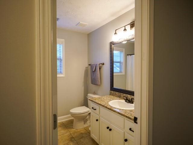 1201 Live Oak Cir, Opelika, AL 36801 - full bathroom with toilet, vanity, and tile patterned floors