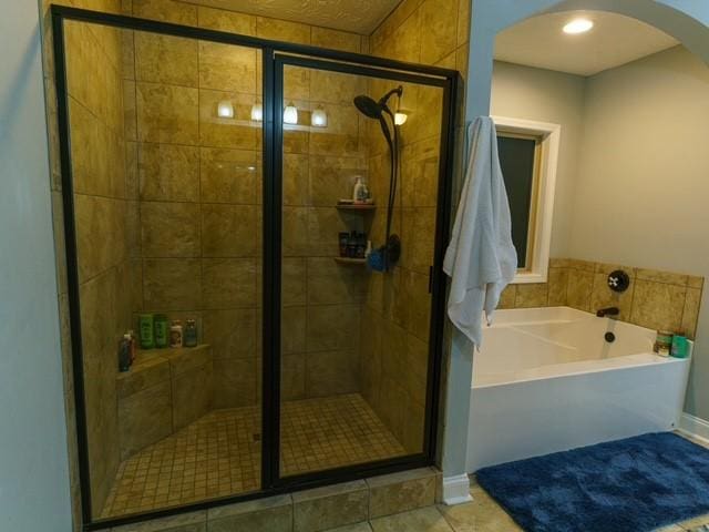 1201 Live Oak Cir, Opelika, AL 36801 - bathroom featuring a bath, a shower stall, and tile patterned floors