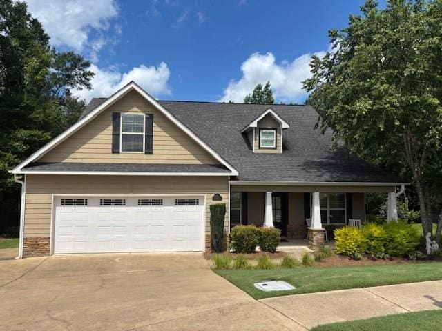1201 Live Oak Cir, Opelika, AL 36801 - craftsman inspired home with a porch, concrete driveway, a garage, and stone siding