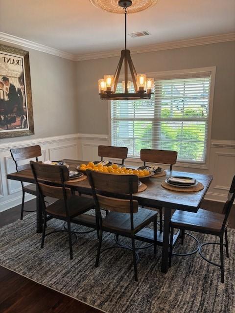1201 Live Oak Cir, Opelika, AL 36801 - dining room featuring a decorative wall, dark wood-style floors, a chandelier, ornamental molding, and a wainscoted wall