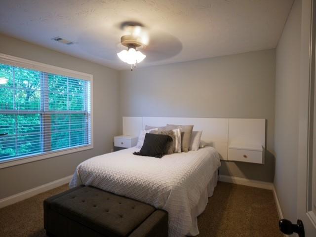 1201 Live Oak Cir, Opelika, AL 36801 - bedroom featuring dark carpet and baseboards