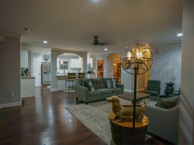 1201 Live Oak Cir, Opelika, AL 36801 - living area with arched walkways, ornamental molding, ceiling fan, dark wood-type flooring, and baseboards