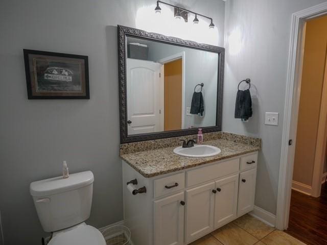 1201 Live Oak Cir, Opelika, AL 36801 - half bath with vanity, toilet, tile patterned flooring, and baseboards