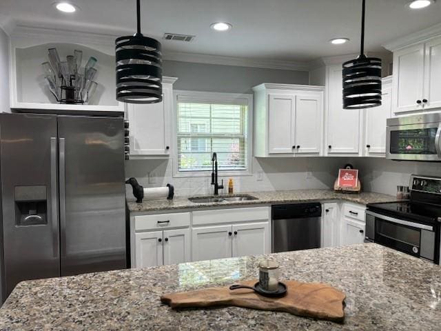 1201 Live Oak Cir, Opelika, AL 36801 - kitchen featuring appliances with stainless steel finishes, white cabinetry, light stone counters, recessed lighting, and crown molding