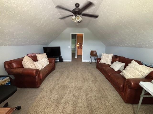 1201 Live Oak Cir, Opelika, AL 36801 - living room with a textured ceiling, carpet flooring, a ceiling fan, and lofted ceiling