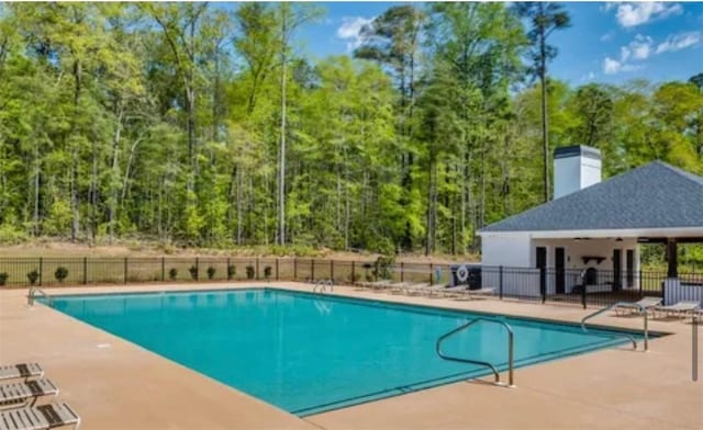 1201 Live Oak Cir, Opelika, AL 36801 - community pool featuring a patio area and a forest view