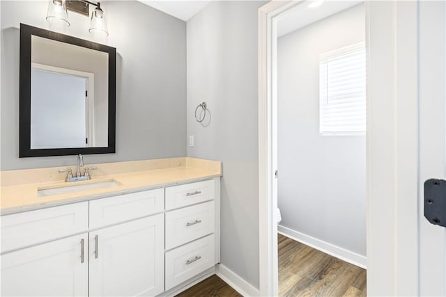 bathroom with vanity, hardwood / wood-style flooring, and toilet