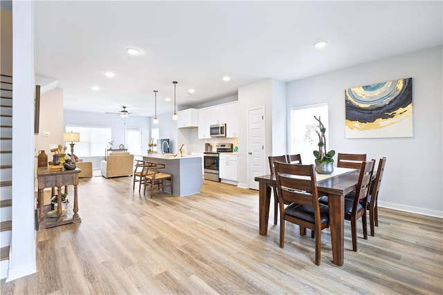 dining area featuring ceiling fan and light hardwood / wood-style floors