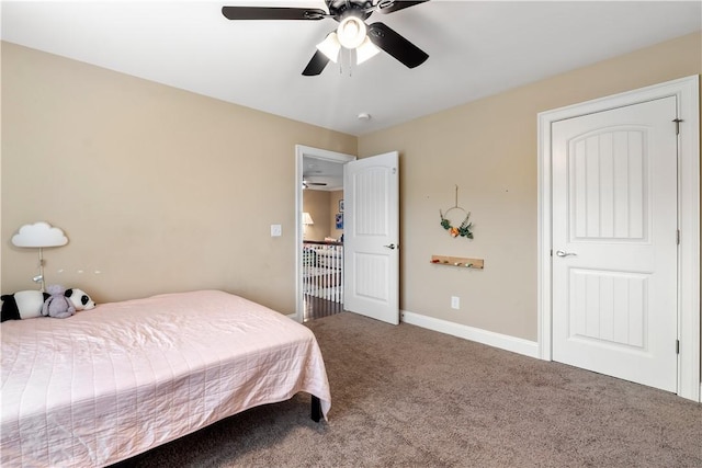bedroom with ceiling fan, baseboards, and carpet